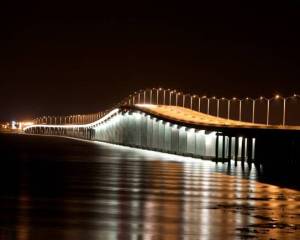 Bay St. Louis bridge illuminated at night — the heart of our coastal community